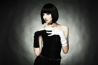 Fashion portrait of young beautiful woman in the black dress