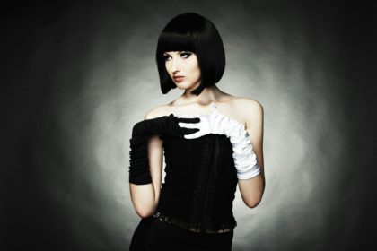 Fashion portrait of young beautiful woman in the black dress