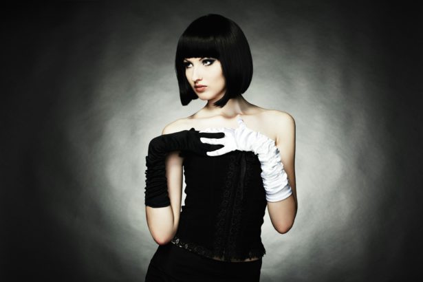 Fashion portrait of young beautiful woman in the black dress